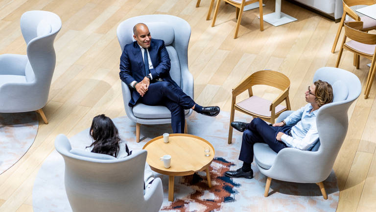 3 Lazard Colleagues in Paris Sitting in Armchairs Around Coffee Table